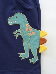 Kids navy knit cotton shorts featuring a green dinosaur applique with yellow felt 3D fins