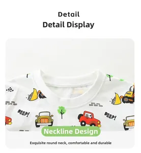 Détail du col rond et de l'imprimé pelleteuse sur un t-shirt blanc pour enfants en coton doux