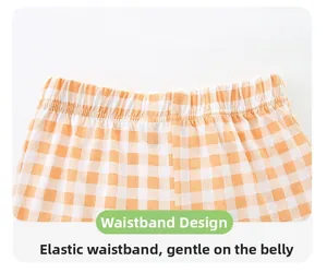 Detail view of children's orange checkered shorts with a comfortable elastic waistband