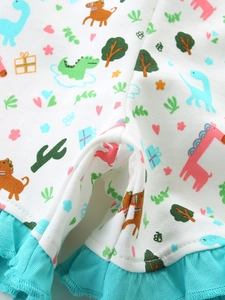Girls' cotton knit shorts with colorful animal prints and teal ruffled hem detail