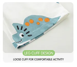 Detail of baby pants hem with cute blue cartoon dinosaur print and clean machine stitching
