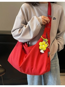 Red pleated canvas hobo bag with large capacity and yellow sunflower charm detail
