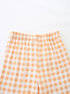 Kids orange gingham plaid shorts featuring a flexible elastic waistband and soft cotton fabric