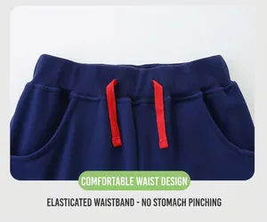 Detail of navy knit cotton shorts with elastic ribbed waistband and red drawstring