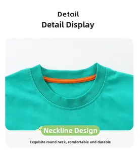 Detail of boys' green cotton T-shirt featuring a ribbed crew neck with orange contrast piping