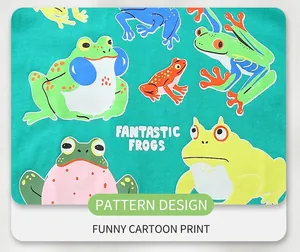 Detail of green cotton fabric featuring vibrant cartoon frog prints and artistic lettering