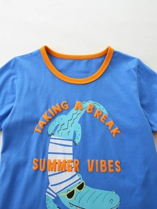 Boy's summer set featuring a blue crocodile print t-shirt and plaid shorts outfit