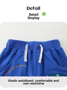 Macro view of blue boys cotton shorts featuring an elastic waistband and white drawstring