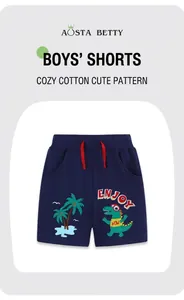 Close-up of boys' cotton shorts featuring dinosaur embroidery and red drawstring