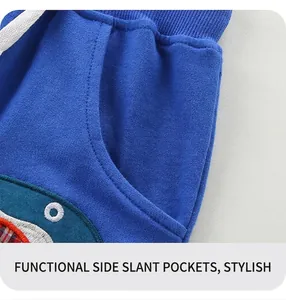Detail of boys navy knit shorts showing side pocket and shark embroidery design