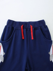 Kids navy knit sports shorts with red drawstring and cute shark embroidery detail