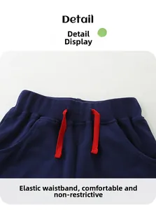 Detail of navy knit shorts featuring elastic waistband and contrast red drawstrings