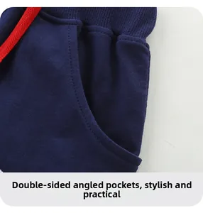 Detail of navy knit shorts with ribbed waistband, red drawstrings and slanted pockets
