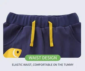 Detail of navy knit shorts featuring yellow drawstring and elastic waistband for boys