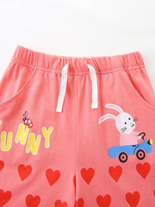 Pink toddler shorts with rabbit embroidery and elastic drawstring waist flat lay view