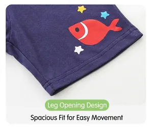 Close-up of boys' blue summer shorts featuring red fish and yellow star print details