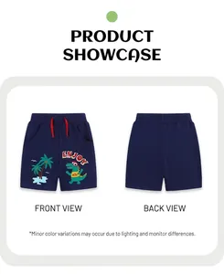 Detail of navy cotton shorts with green dinosaur embroidery and red drawstring