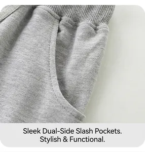 Detail of grey cotton shorts showing elastic ribbed waistband and side slash pockets
