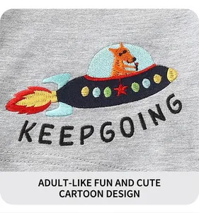 Macro detail of cartoon fox in rocket embroidery on grey boy shorts with Keep Going text
