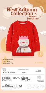 Détail d'un sweat rouge 100 % coton pour filles avec pois et broderie bonhomme de neige