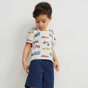 Close-up of boys summer cotton set featuring vintage car prints on T-shirt and navy shorts