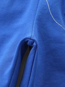 Macro view of blue knit shark embroidered boy's shorts with white contrast stitching detail