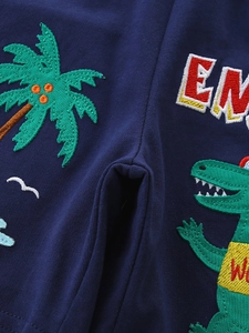 Boys navy cotton knit shorts featuring embroidered cartoon dinosaur and palm tree details