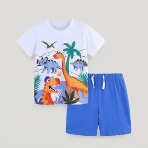 Detail of white cotton boy's t-shirt with dinosaur print and blue drawstring shorts set