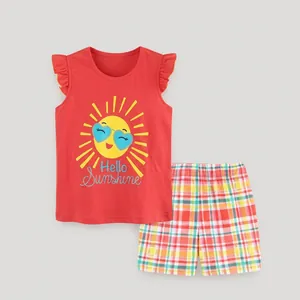 Detail of red sleeveless top with ruffled sleeves and colorful plaid shorts set