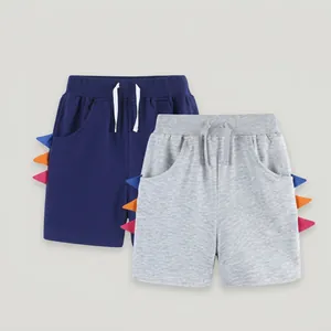 Detail of kids cotton shorts with 3D dinosaur spike side trim and elastic waist