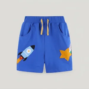 Detail of blue cotton boy shorts featuring elastic waistband and rocket embroidery