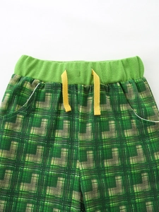 Boys green plaid shorts set with elastic drawstring waist and excavators print design