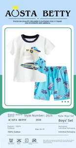 Detail view of cotton summer set with dinosaur t-shirt and coconut print shorts for boys