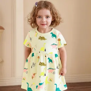 Detailed close-up of girls cotton dress with cartoon dinosaur and rainbow prints