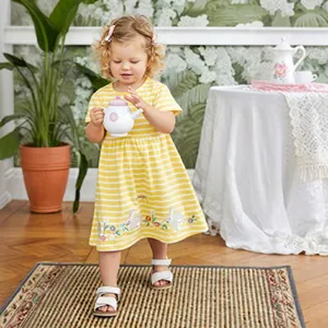 Close-up of baby girl dress featuring yellow stripes and rabbit floral embroidery