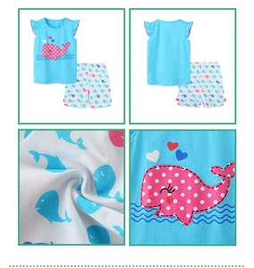 Detail view of cotton summer set featuring whale prints and flutter sleeves for girls