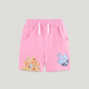 Detailed view of pink girls' cotton shorts with elastic waistband and floral embroidery