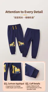 Detail of navy blue boys' joggers showing yellow excavator embroidery and ribbed ankle cuffs