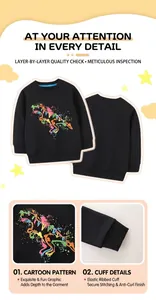 Close-up of colorful dinosaur print and ribbed cuffs on black long sleeve kid's sweatshirt