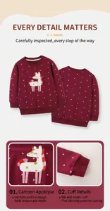 Detail of embroidered unicorn patch and ribbed elastic cuffs on burgundy polka dot girls sweatshirt