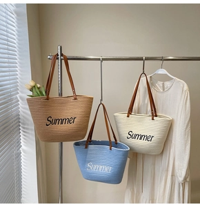 Close-up of three woven tote bags featuring Summer embroidery and brown leather handles