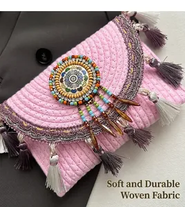 Detailed shot of pink woven bag featuring ethnic mandala beads and colorful tassels