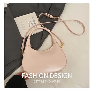 Detail showing smooth light pink crescent bag with gold adjustable buckle and leather texture