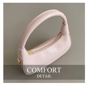 Detail of pink hobo bag featuring smooth PU leather texture and premium gold metal zipper