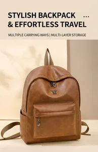Detail view of brown PU leather backpack with metal rabbit logo and front pocket