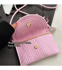Close-up of pink woven crossbody bag featuring a secure magnetic buckle closure design