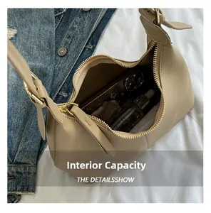 Internal capacity of beige hobo bag holding a smartphone and cosmetic bottle