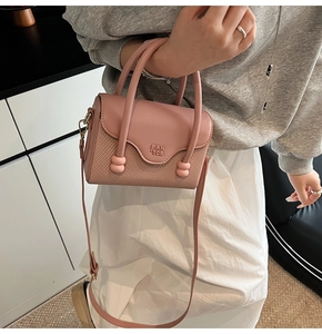 Détail du mini sac bandoulière rose avec textile gaufré et logo PAN TOR imprimé