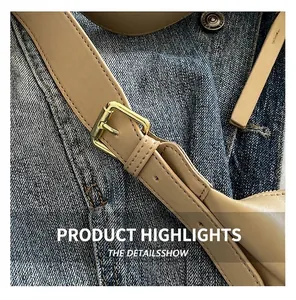 Close-up of golden hardware buckle on beige leather shoulder bag with fine stitching