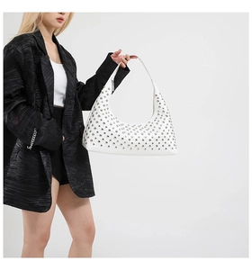 Close-up of white Hobo bag featuring silver rivets and high-quality leather texture
